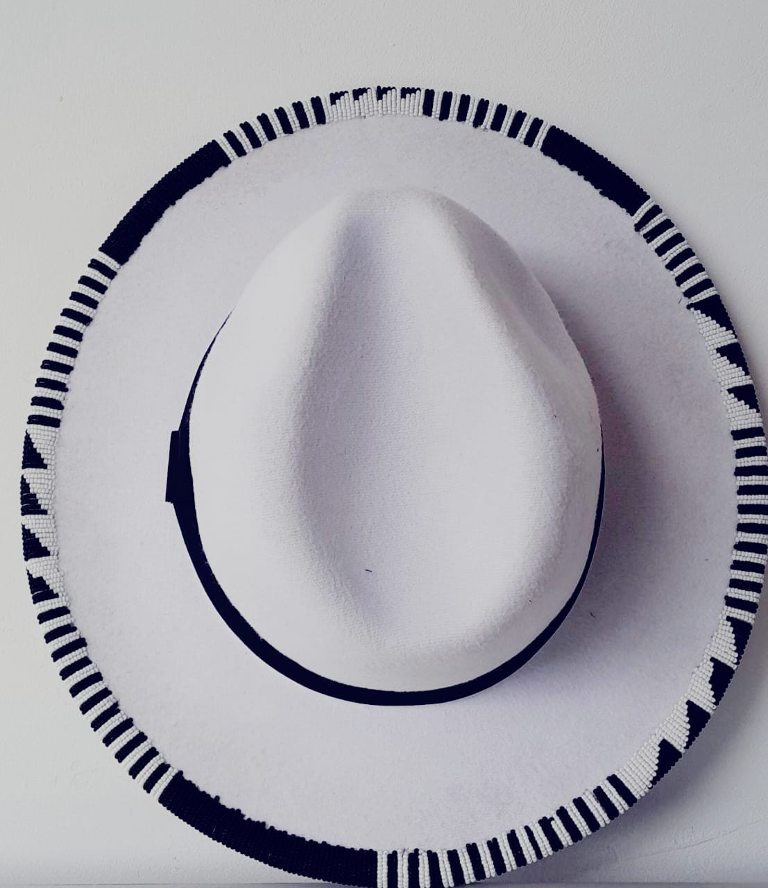 White round bottom Beaded, Fedora Hat , With a structured Wide brim. Adjustable ribbon inside the hat to pull and tighten for a better fit.